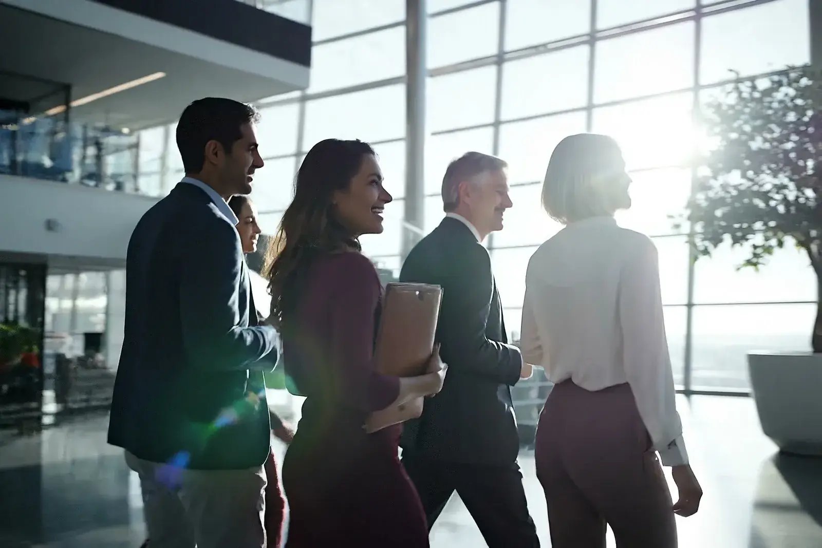 Colleagues walking together through a bright office atrium