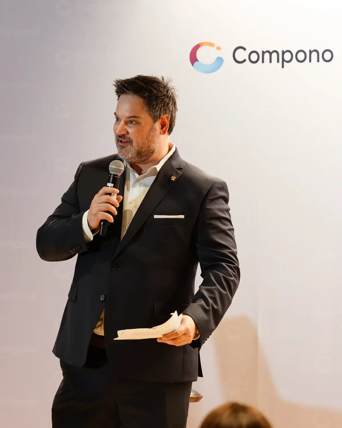 Rudy Crous, Compono's CEO, speaking on stage at a Compono event in Sydney